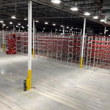 Wide-angle view of a professional multi-aisle pallet racking installation in a large industrial warehouse.